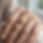 Close-up of a woman wearing an organic peridot gemstone ring on the beach, 316L stainless steel adjustable gold ring
